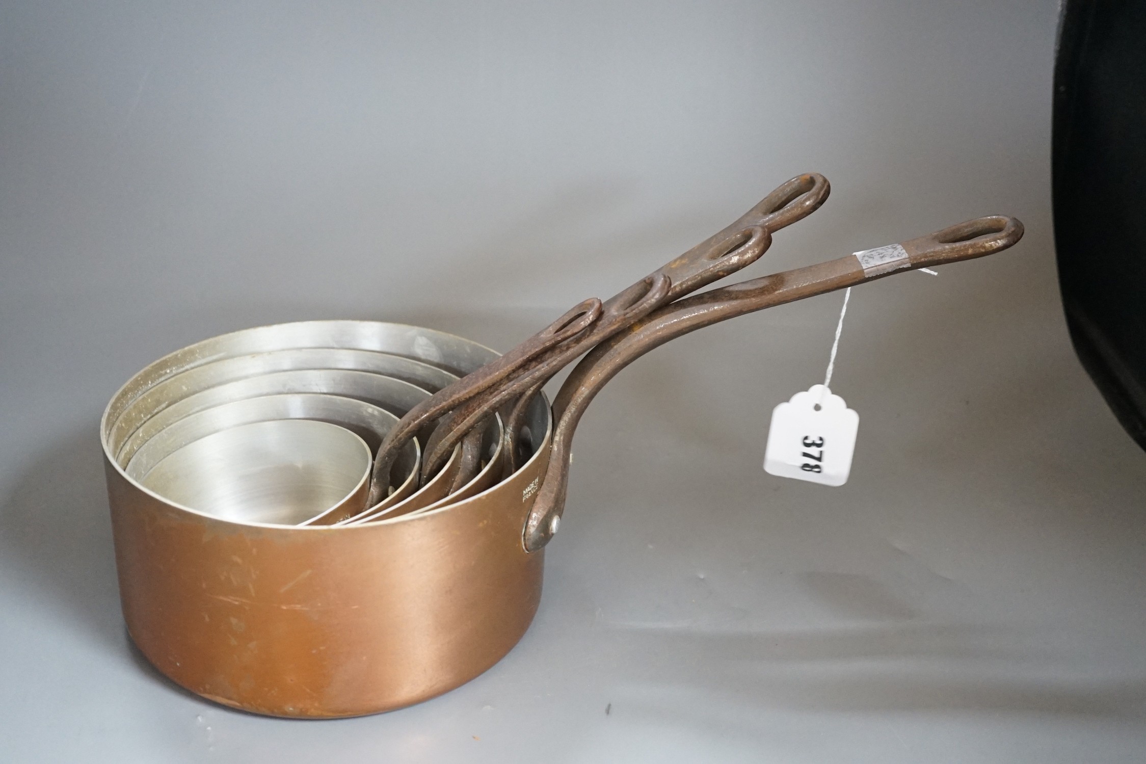 A graduated set of French copper saucepans